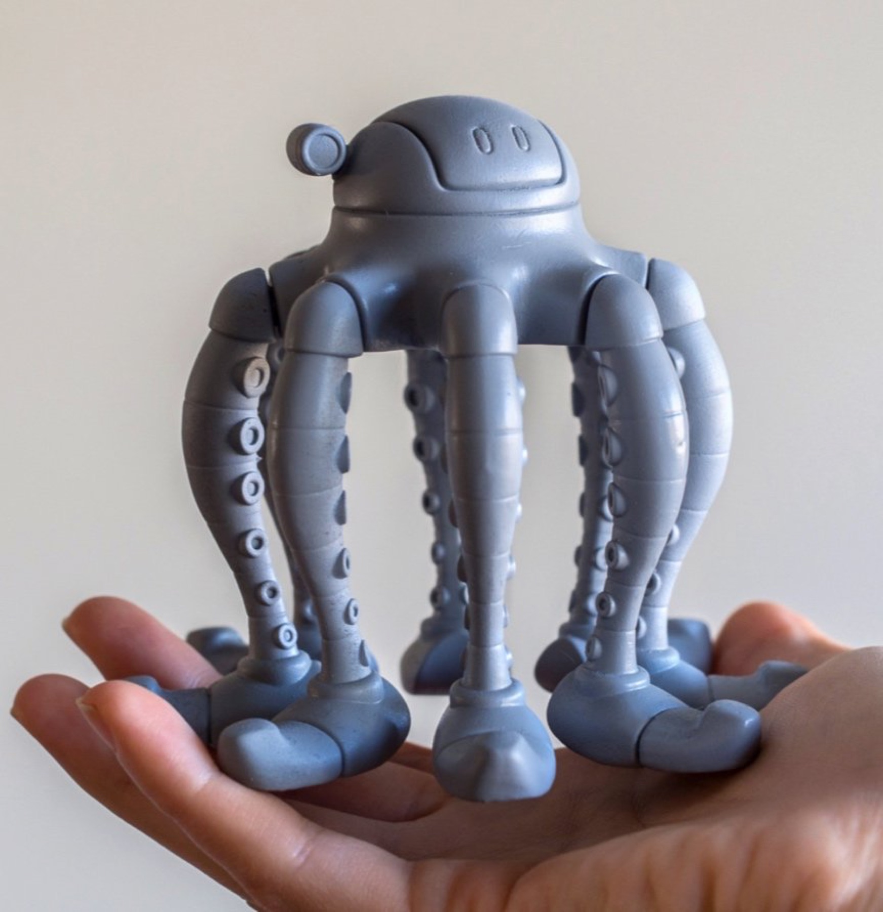 A freshly printed OctoBot in the palm of a hand